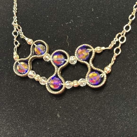 Silver colored chain with 6 purple reflective beads. - Picture 2 of 3